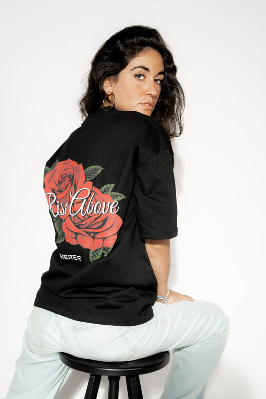 Female model wearing Ascend Rose oversized black t-shirt with rose graphic back print by Sekerer