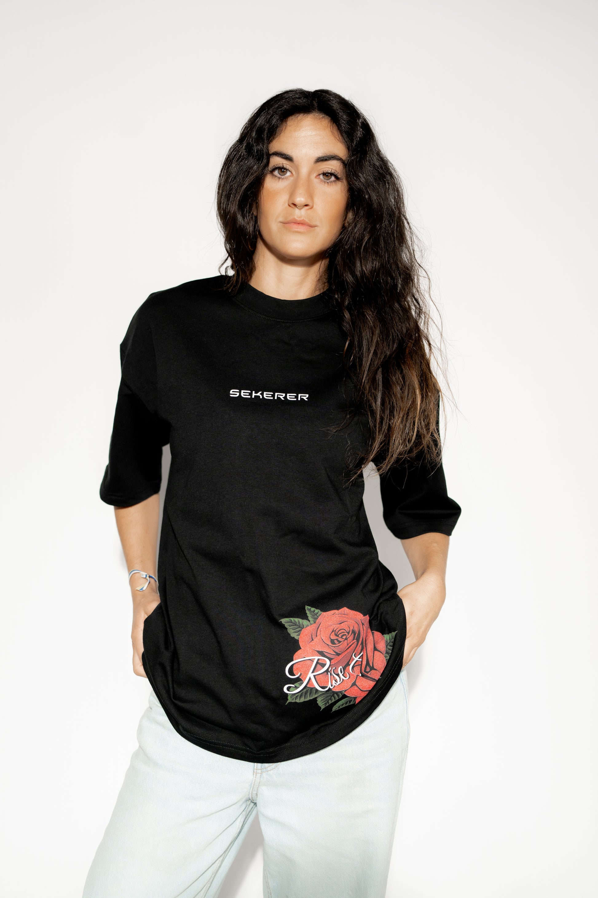 Female model wearing Ascend Rose black oversized t-shirt with rose print detail