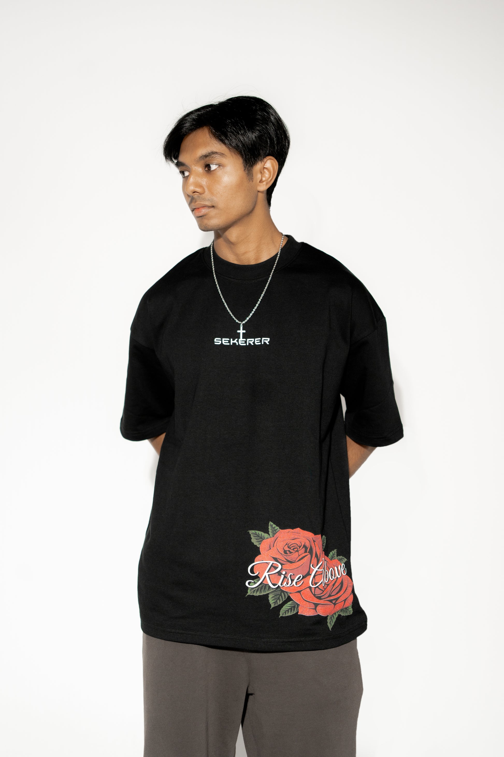 Male model wearing Ascend Rose oversized black t-shirt front view by Sekerer