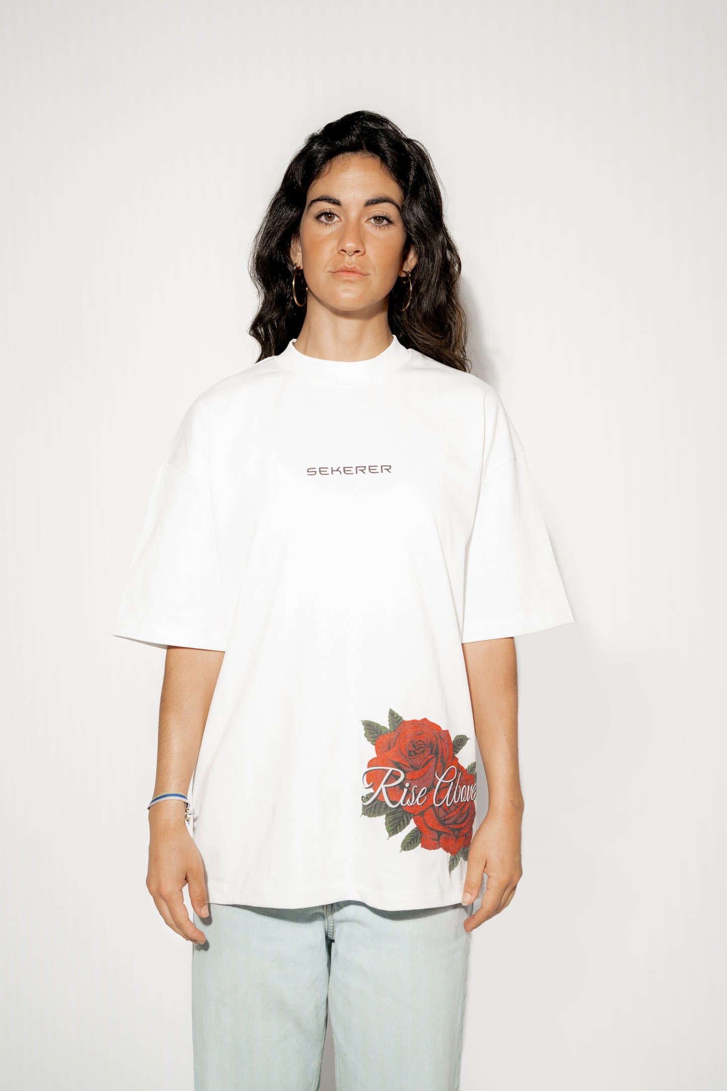 Female model wearing Ascend Rose oversized white t-shirt front view by Sekerer