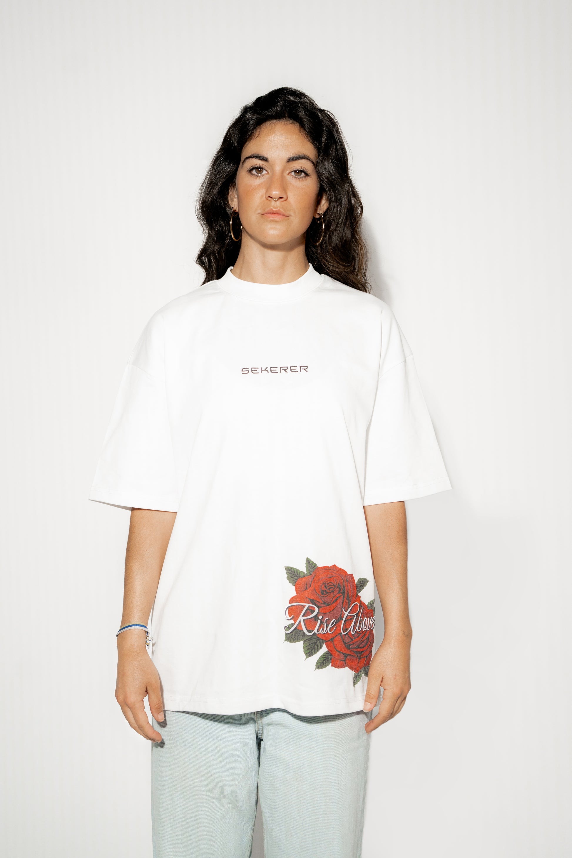 Female model wearing Ascend Rose oversized white t-shirt front view by Sekerer
