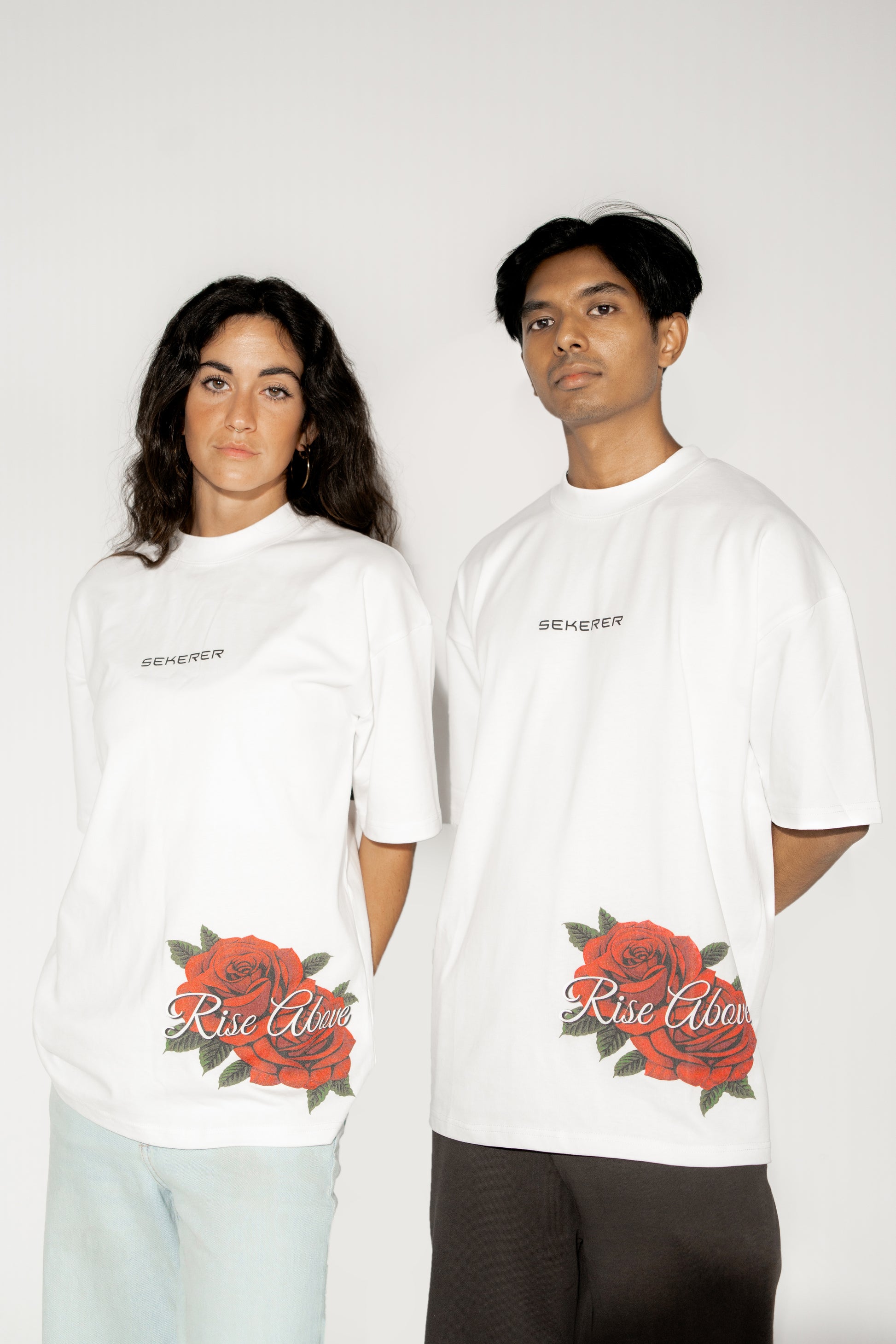 Male and female models wearing Ascend Rose oversized white t-shirt front view by Sekerer