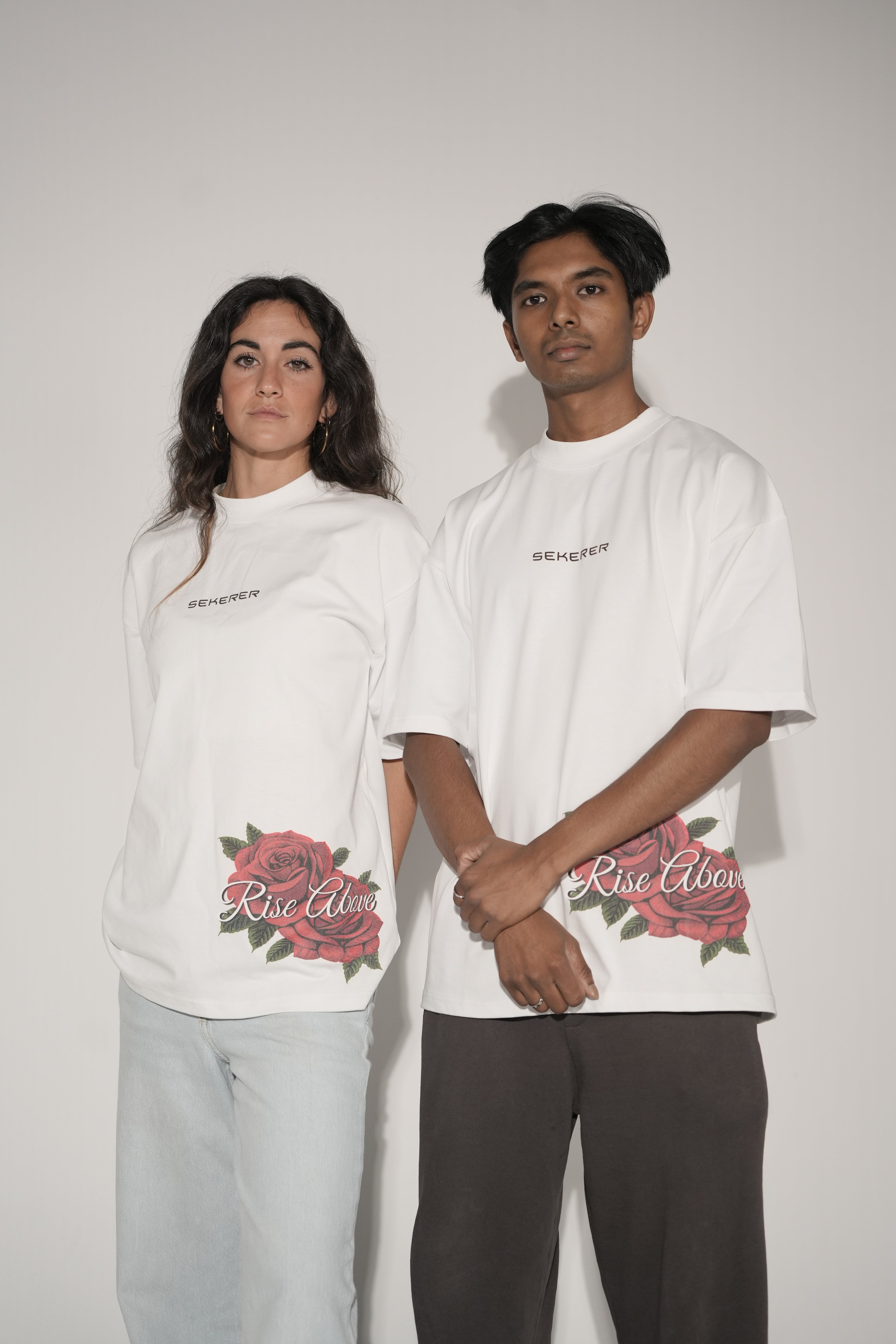 Male and female models wearing Ascend Rose oversized white streetwear t-shirt front view