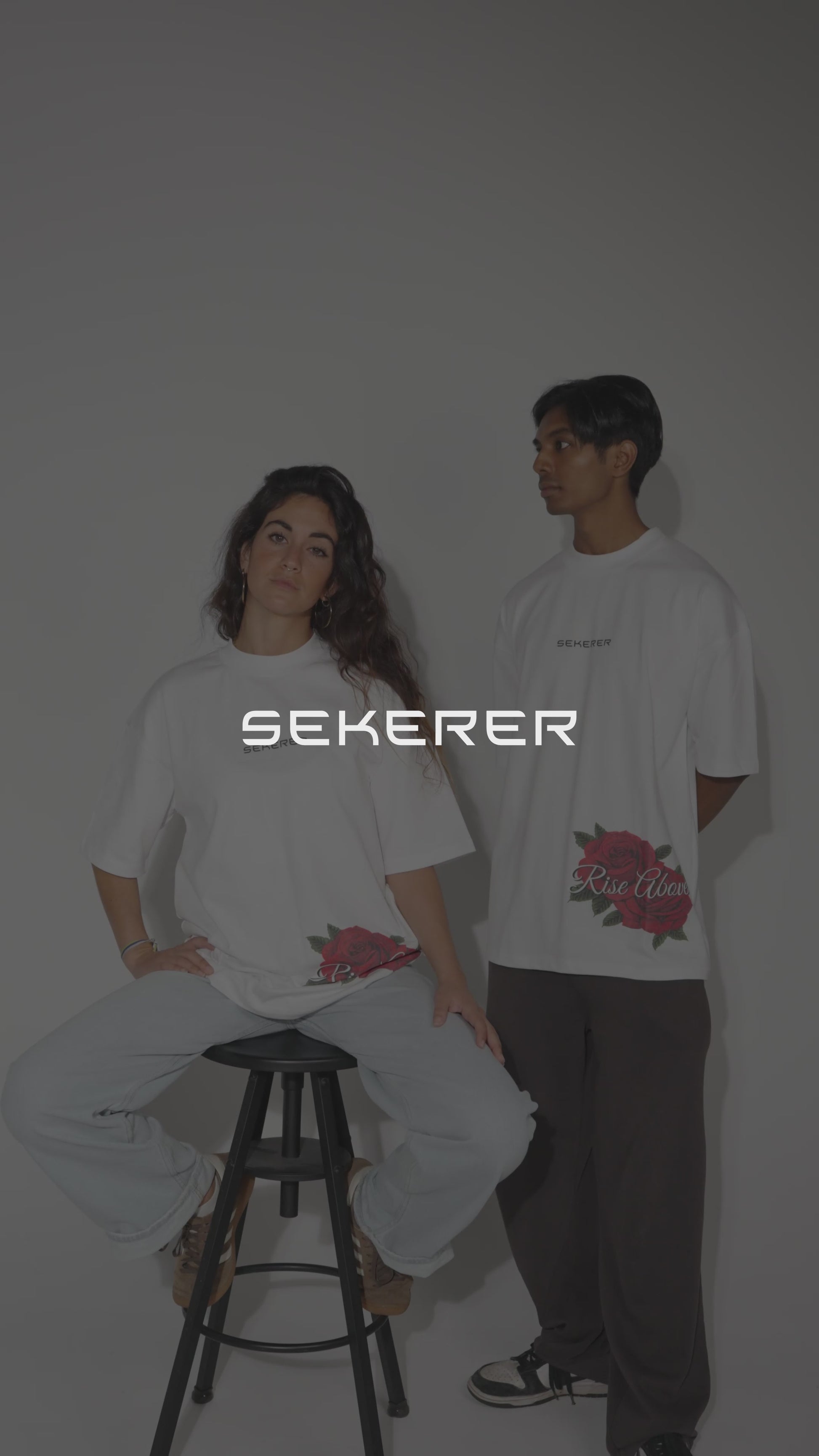Male and female models showcasing Ascend Rose oversized black and white t-shirts by Sekerer