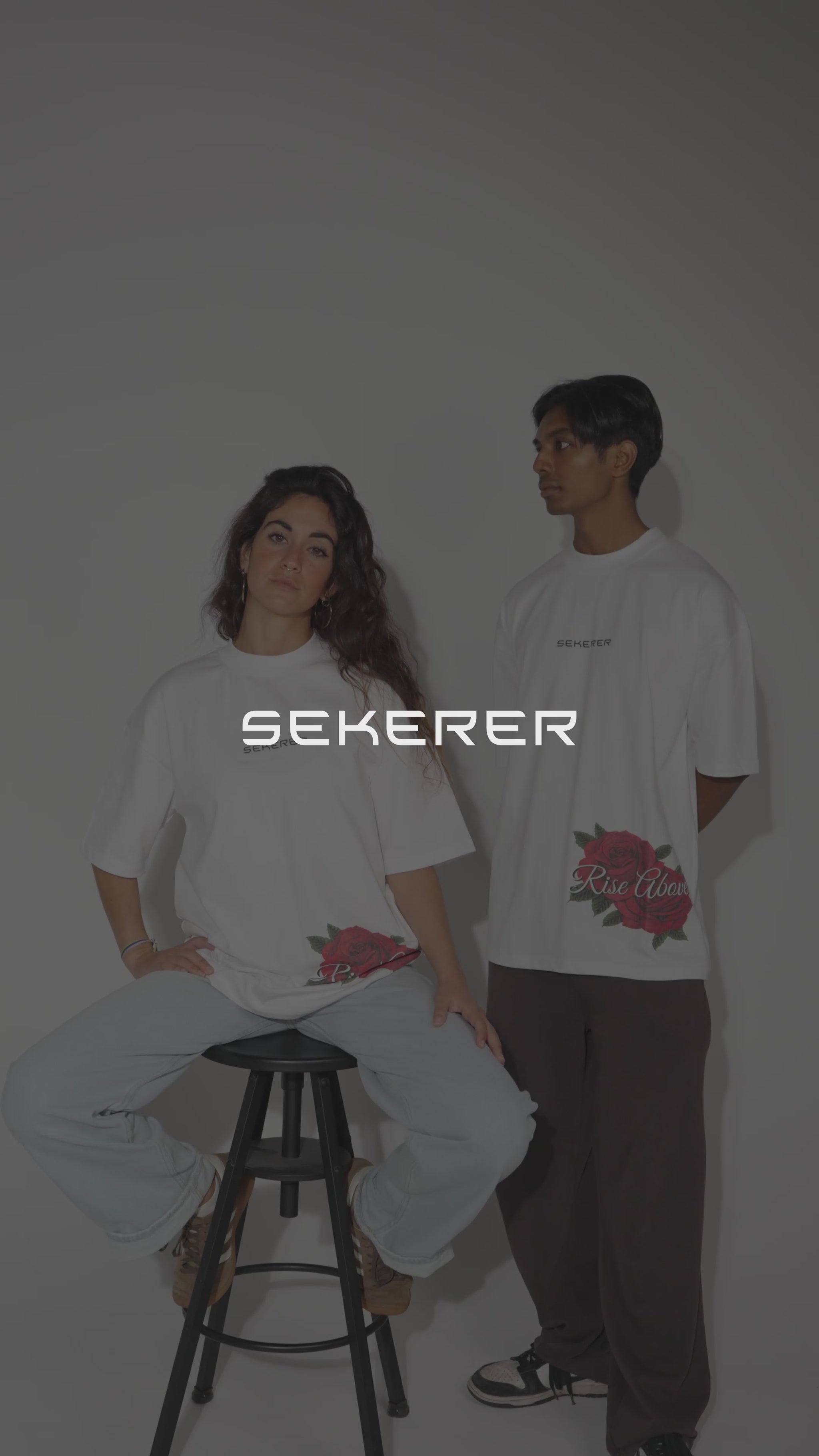 Male and female models showcasing Ascend Rose oversized black and white t-shirts by Sekerer